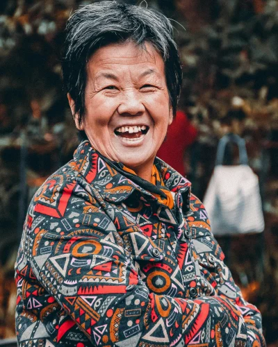 Laughing older woman with arms crossed, radiating good health and happiness. Breath for a long and healthy life.